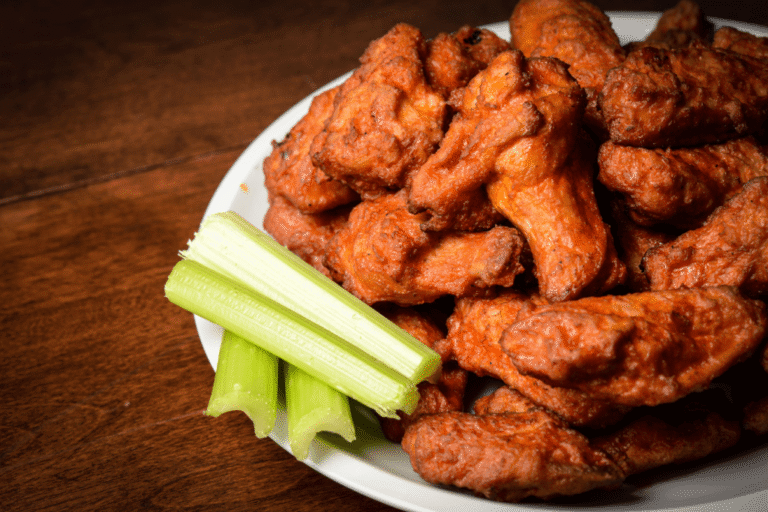 Crispy fried party wings served hot on a platter at Essence Bar — the best soul food in Brooklyn.