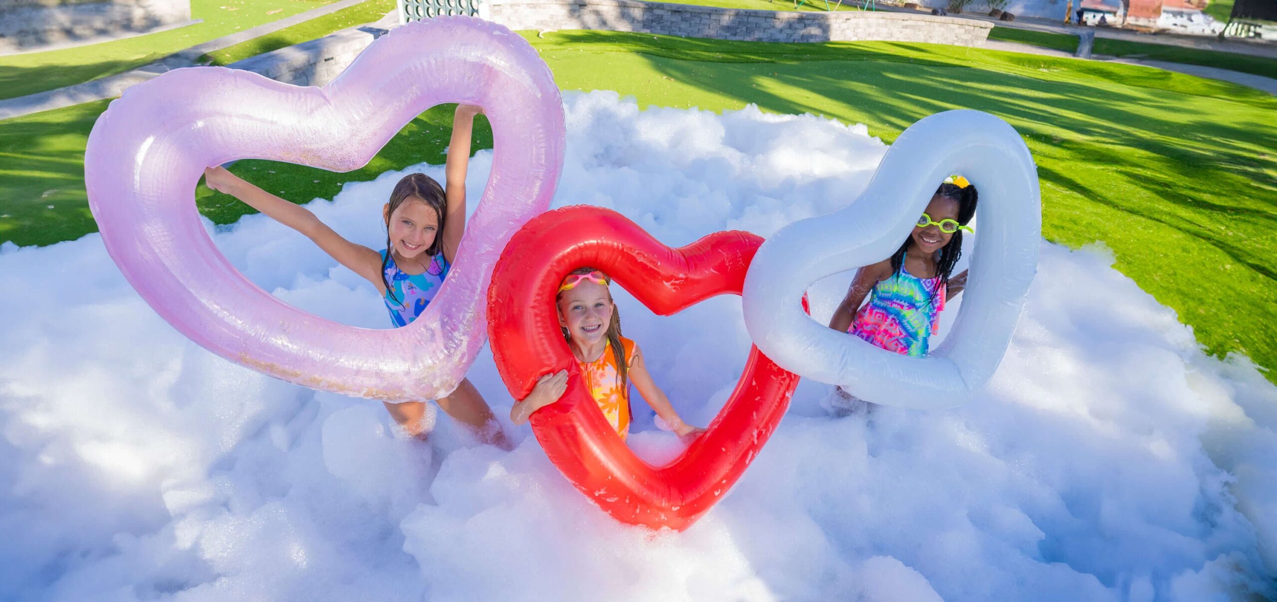 Foam party rentals setup with bubbles, music, and kids having fun.